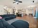 Spacious living room with hardwood floors, ceiling fan, and an open view to the kitchen at 4606 Gatesmills Ave, Charlotte, NC 28213