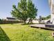 Spacious backyard with mature tree, deck, playground, and privacy fence perfect for outdoor living and entertaining at 4665 Madeline Dr, Rock Hill, SC 29732