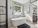 Bright bathroom featuring a freestanding soaking tub next to a black grid shower at 4665 Madeline Dr, Rock Hill, SC 29732