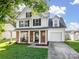 Charming two-story home featuring a brick and white-siding facade, covered porch, and attached garage at 4665 Madeline Dr, Rock Hill, SC 29732
