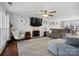 Spacious living room with fireplace, ceiling fan, and ample natural light at 4665 Madeline Dr, Rock Hill, SC 29732