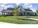 Beautiful clubhouse with a stone chimney and green lawn at 5043 Antebellum Dr, Iron Station, NC 28080