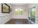 Elegant dining room featuring hardwood floors, decorative wall molding, and a sliding glass door to the outdoor space at 5043 Antebellum Dr, Iron Station, NC 28080