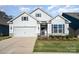 Charming single-Gathering home with a well-manicured lawn and attached two-car garage at 5043 Antebellum Dr, Iron Station, NC 28080