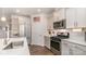 Updated kitchen with stainless steel appliances, subway tile backsplash, and island with sink at 5043 Antebellum Dr, Iron Station, NC 28080