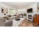 Comfortable living room with a fireplace, neutral furniture, and a large window offering natural light at 5043 Antebellum Dr, Iron Station, NC 28080