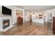 Open-concept living space with hardwood floors, a fireplace, and a modern kitchen with stainless steel appliances at 5043 Antebellum Dr, Iron Station, NC 28080