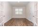 Bright office space with hardwood floors, a large window, and minimalist decor, perfect for productivity at 5043 Antebellum Dr, Iron Station, NC 28080