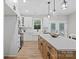 Open kitchen boasts a large center island with white countertop, stainless appliances and access to the outdoor patio at 528 Waco Rd, Kings Mountain, NC 28086