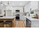 Bright kitchen features white cabinets, a marble backsplash, stainless steel appliances, and a large island at 528 Waco Rd, Kings Mountain, NC 28086