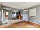 Open-concept living area featuring hardwood floors, a fresh gray paint scheme, and natural light from the windows at 545 S Green St, Statesville, NC 28677
