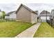The backyard features a practical cement walkway and a secure, fenced-in perimeter at 6433 Raffia Rd, Charlotte, NC 28277