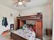 A bedroom with a bunk bed, ceiling fan, natural light, and carpeted floors at 6433 Raffia Rd, Charlotte, NC 28277