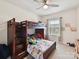 A bedroom with a bunk bed, ceiling fan, natural light, and carpeted floors at 6433 Raffia Rd, Charlotte, NC 28277