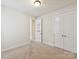 A cozy bedroom with neutral carpet, natural light and a closet that provides ample storage space at 6433 Raffia Rd, Charlotte, NC 28277