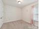 A charming bedroom with neutral carpet, natural light, and cute rainbow decals on the wall at 6433 Raffia Rd, Charlotte, NC 28277