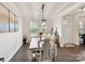 Elegant dining room featuring a stylish table set and ample natural light at 6433 Raffia Rd, Charlotte, NC 28277
