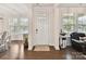 Bright entryway with hardwood floors and a golf bag, near the dining and living areas at 6433 Raffia Rd, Charlotte, NC 28277