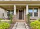 Inviting front porch with seating area and decorative columns at 6433 Raffia Rd, Charlotte, NC 28277