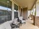 Cozy front porch featuring comfortable seating and ample natural light at 6433 Raffia Rd, Charlotte, NC 28277