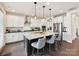 Bright kitchen with white cabinets, a large island with seating, and stainless steel appliances at 6433 Raffia Rd, Charlotte, NC 28277