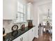 Kitchen nook with black granite countertop, white cabinets and view into dining room at 6433 Raffia Rd, Charlotte, NC 28277