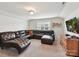 Living room with carpet and a large leather sectional at 6433 Raffia Rd, Charlotte, NC 28277