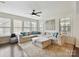 Bright living room featuring a large sectional, ceiling fan, and abundant natural light at 6433 Raffia Rd, Charlotte, NC 28277