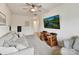 Inviting living room with a sofa, ceiling fan, desk, and wall-mounted television at 6433 Raffia Rd, Charlotte, NC 28277