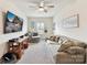 Comfortable living room with sofa, ceiling fan, and wall-mounted television at 6433 Raffia Rd, Charlotte, NC 28277