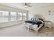 Serene main bedroom features a large bed, tray ceiling, and ample natural light at 6433 Raffia Rd, Charlotte, NC 28277