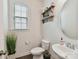 Charming powder room featuring a modern sink, stylish shelving, and natural light at 6433 Raffia Rd, Charlotte, NC 28277