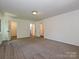 Bedroom featuring carpet, neutral paint, and doorways leading to closets and the bathroom at 6745 Thermal Rd, Charlotte, NC 28211