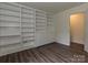 Bright room featuring a wall of white built-in shelving and a door to the side at 6745 Thermal Rd, Charlotte, NC 28211