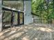Inviting wooden deck with large windows and wood railing, ideal for enjoying the outdoors with the trees in the background at 6745 Thermal Rd, Charlotte, NC 28211