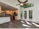 Bright dining room features wood floors, a ceiling fan, and access to the kitchen and deck at 6745 Thermal Rd, Charlotte, NC 28211