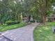 A view of the home and the long driveway, and the garage, surrounded by mature trees at 6745 Thermal Rd, Charlotte, NC 28211