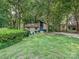 A view of the front of the house on a large manicured lot surrounded by mature trees at 6745 Thermal Rd, Charlotte, NC 28211