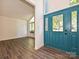Foyer features a blue front door, wood floors, and lots of natural light at 6745 Thermal Rd, Charlotte, NC 28211
