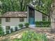 Charming home featuring a unique roofline, a blue front door, and mature landscaping at 6745 Thermal Rd, Charlotte, NC 28211