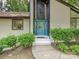 A close up of the front door, which is blue, and surrounded by bushes and windows at 6745 Thermal Rd, Charlotte, NC 28211
