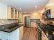 Modern kitchen with granite countertops, stainless steel appliances, and updated cabinets at 6745 Thermal Rd, Charlotte, NC 28211
