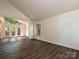 A spacious living room with wood floors is open to the kitchen and leads to a deck at 6745 Thermal Rd, Charlotte, NC 28211