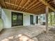 Covered outdoor patio features brick wall, double doors, and concrete flooring, perfect for entertaining or relaxing at 6745 Thermal Rd, Charlotte, NC 28211