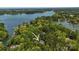 Stunning aerial view of property nestled amongst trees, with a beautiful lake in the distance at 705 Normandy Rd, Mooresville, NC 28117