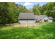 Large backyard with a fenced garden area, perfect for planting, set against a backdrop of mature trees at 705 Normandy Rd, Mooresville, NC 28117