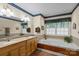 This bathroom features a double vanity, shower and large soaking tub with tiled walls and floor at 705 Normandy Rd, Mooresville, NC 28117
