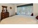 Relax in this cozy bedroom with a window seat and large window providing ample natural light and views of the outdoors at 705 Normandy Rd, Mooresville, NC 28117