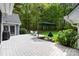 Outdoor deck with grill and patio seating, surrounded by lush greenery and trees at 705 Normandy Rd, Mooresville, NC 28117
