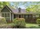 Charming home featuring a cozy front porch and lush landscaping, perfect for enjoying the outdoors at 705 Normandy Rd, Mooresville, NC 28117